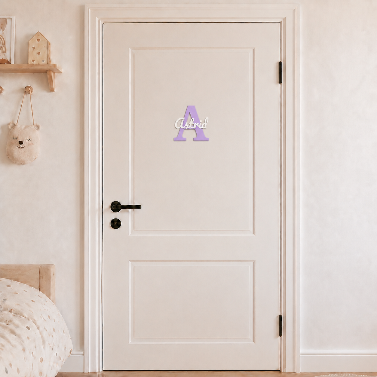 Purple 3D printed letter A name sign with the name Astrid in white script, mounted on a child's bedroom door