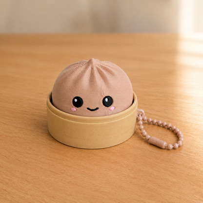 Latte Brown dumpling fidget clicker keychain in its bamboo steamer basket, with ball chain