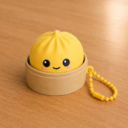 Lemon Yellow dumpling fidget clicker keychain in its bamboo steamer basket, with ball chain