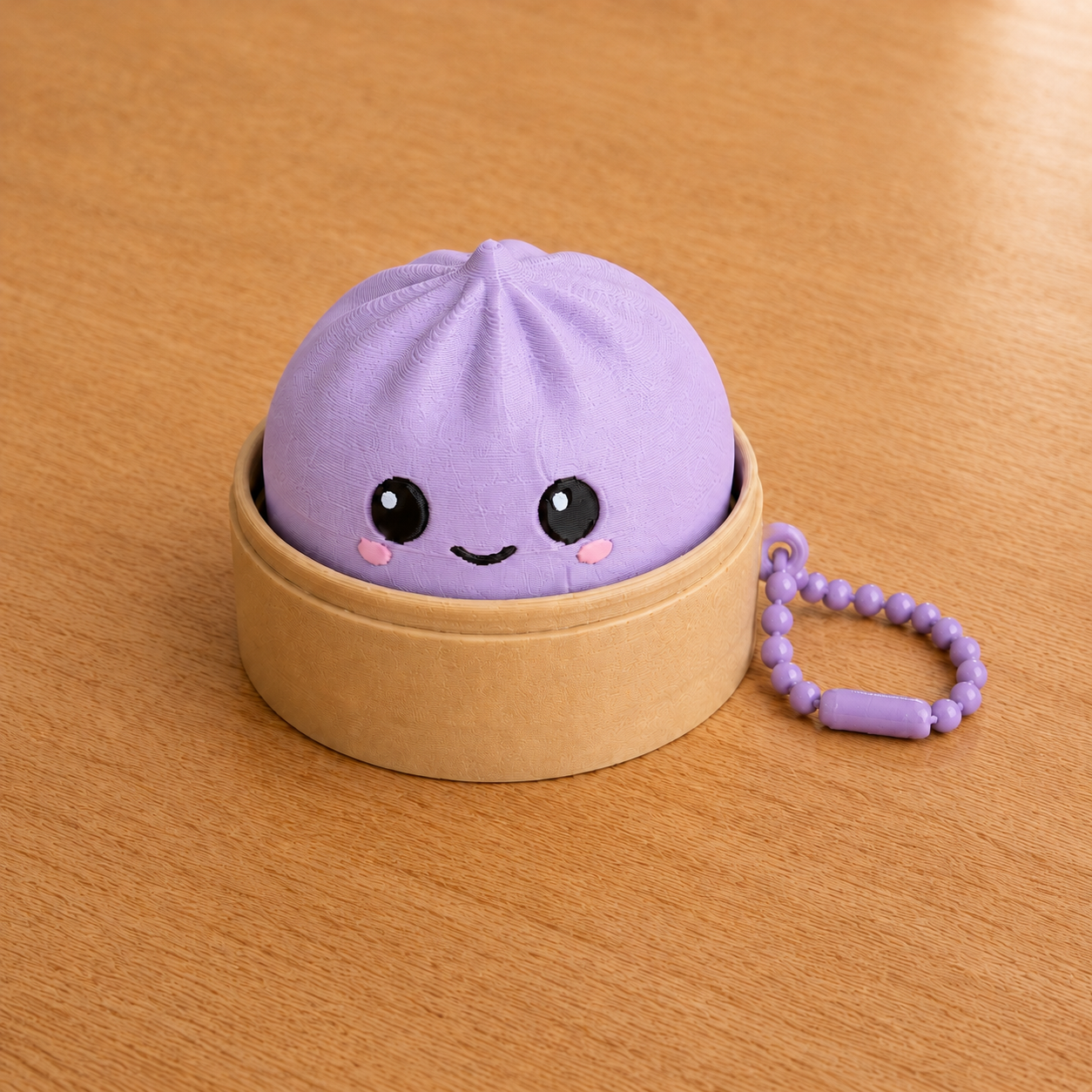Lilac Purple dumpling fidget clicker keychain in its bamboo steamer basket, with ball chain