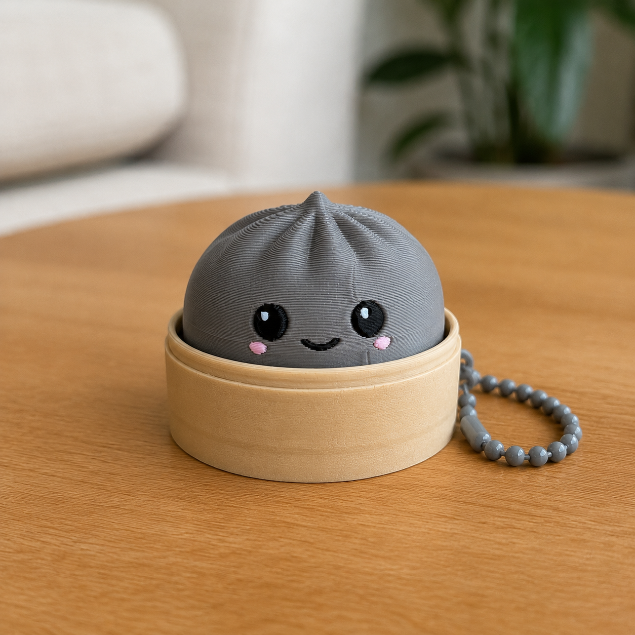 Nardo Gray dumpling fidget clicker keychain in its bamboo steamer basket, with ball chain