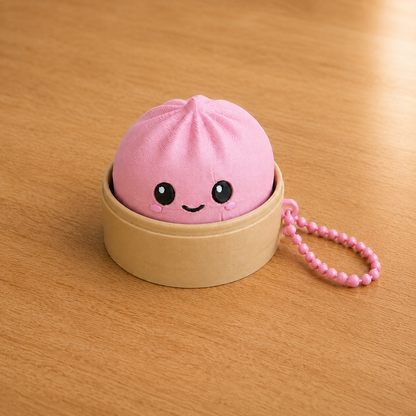 Sakura Pink dumpling fidget clicker keychain in its bamboo steamer basket, with ball chain