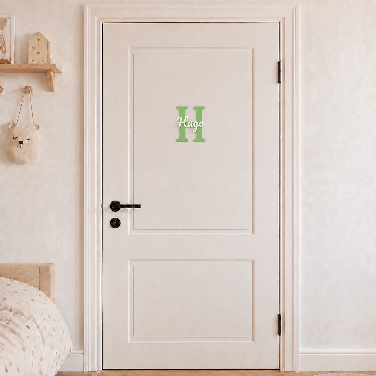 Green 3D printed letter H name sign with the name Hugo in white script, mounted on a child's bedroom door