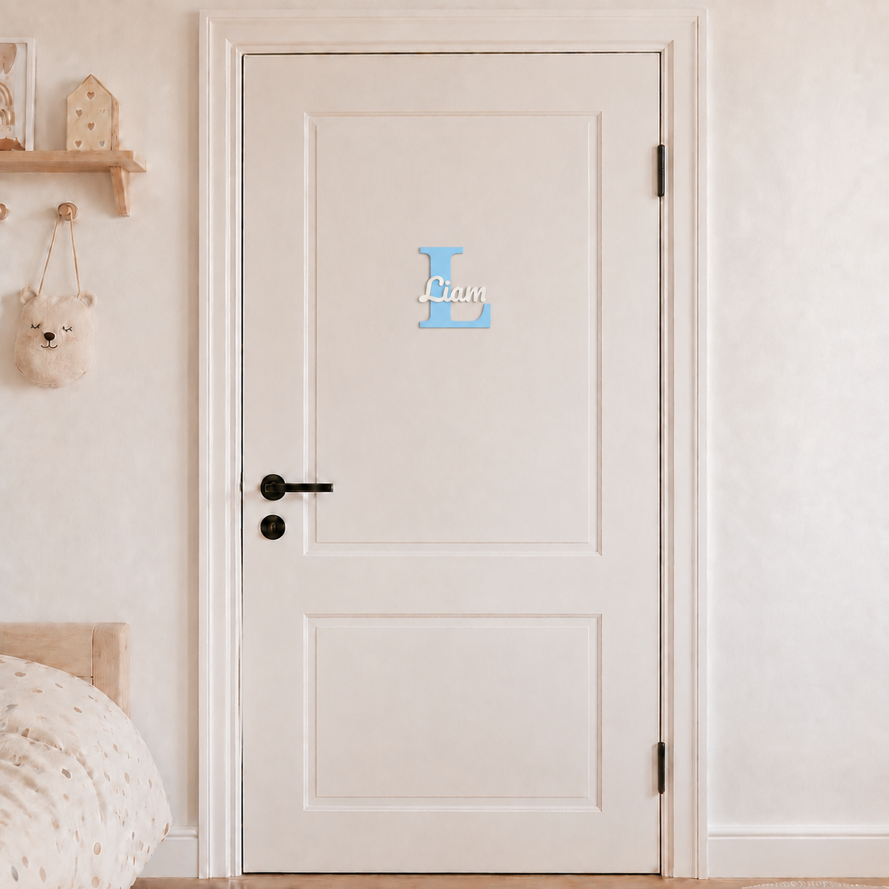 Light blue 3D printed letter L name sign with the name Liam in white script, mounted on a child's bedroom door