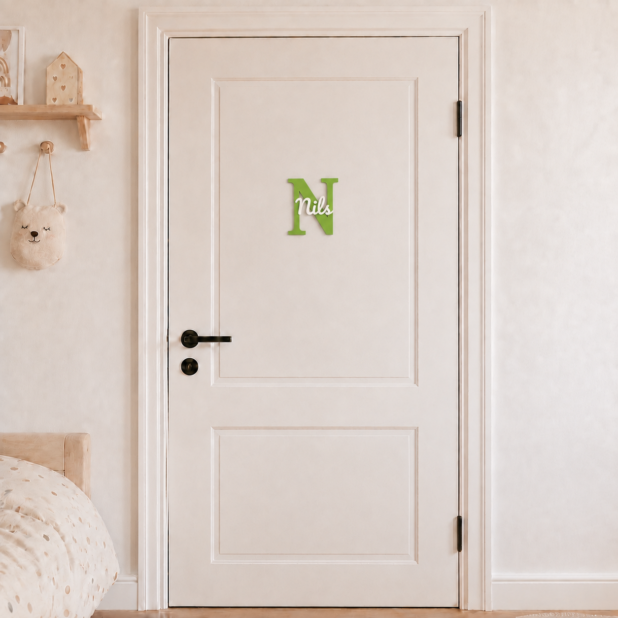 Green 3D printed letter N name sign with the name Nils in white script, mounted on a child's bedroom door