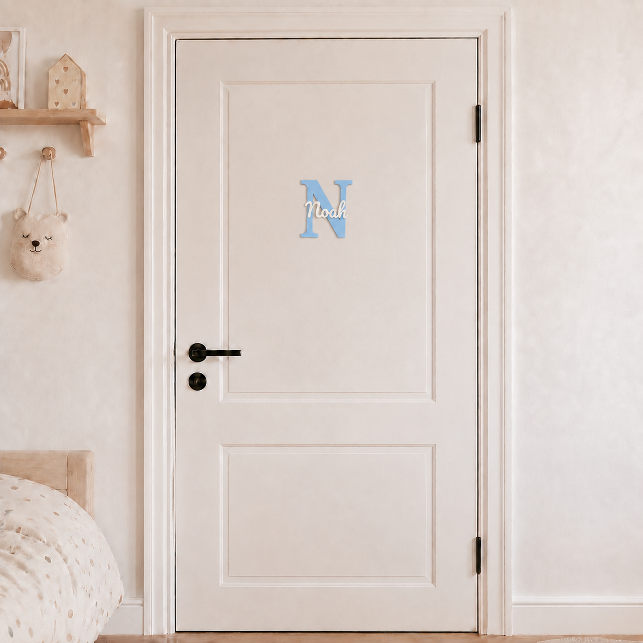 Light blue 3D printed letter N name sign with the name Noah in white script, mounted on a child's bedroom door