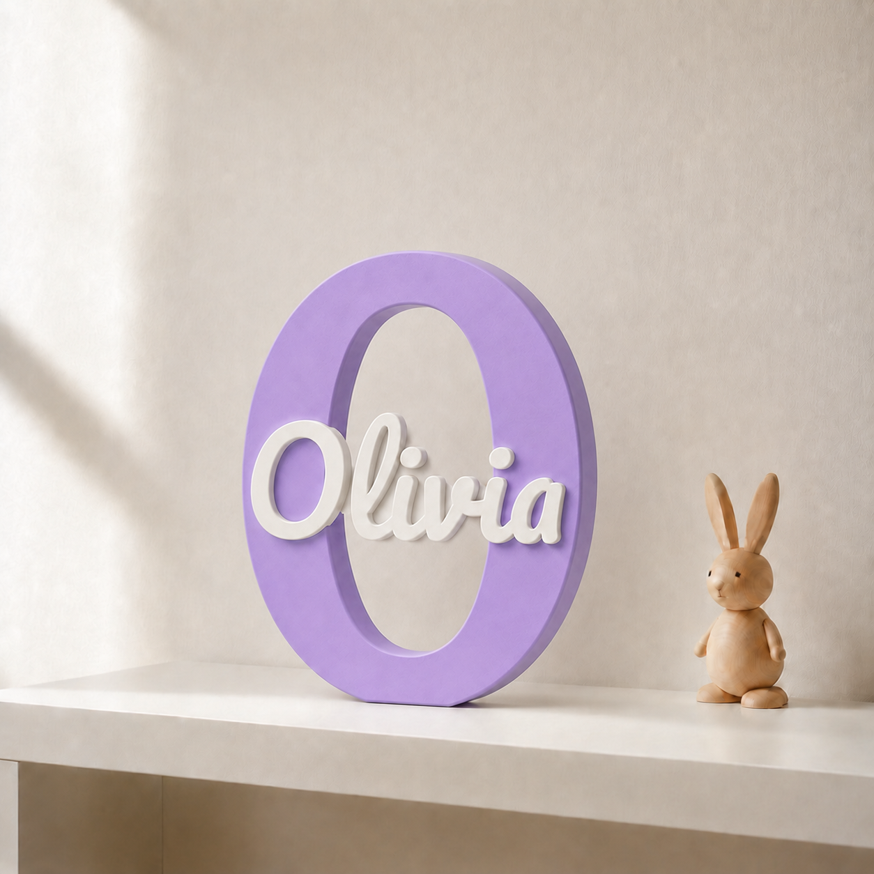 Purple 3D printed letter O name sign with the name Olivia in white script, standing on a shelf