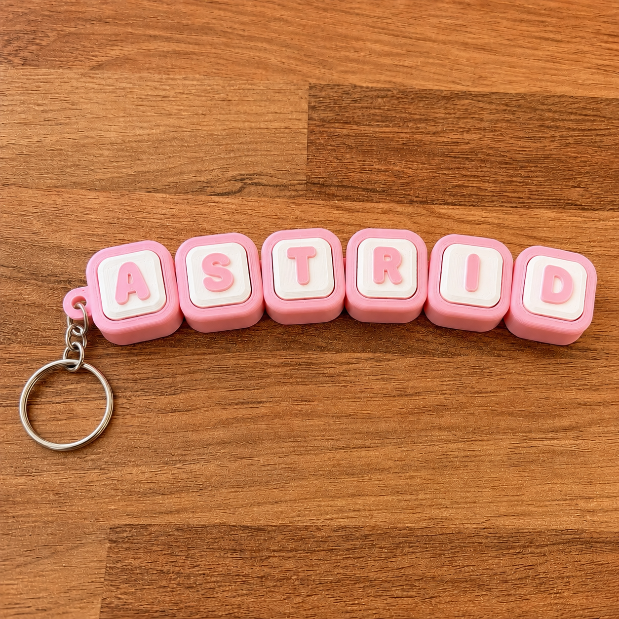 Personalized name tag clicker keyring 'Astrid' — pink steel keyring, 3D printed