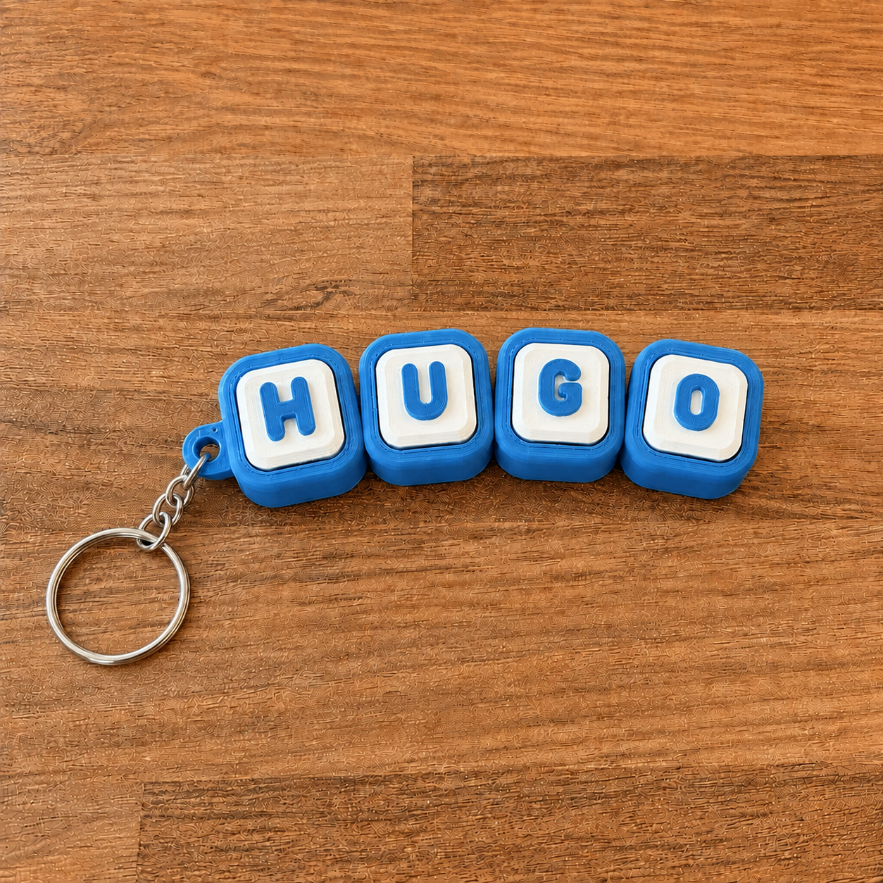 Personalized name tag clicker keyring 'Hugo' — blue steel keyring, 3D printed