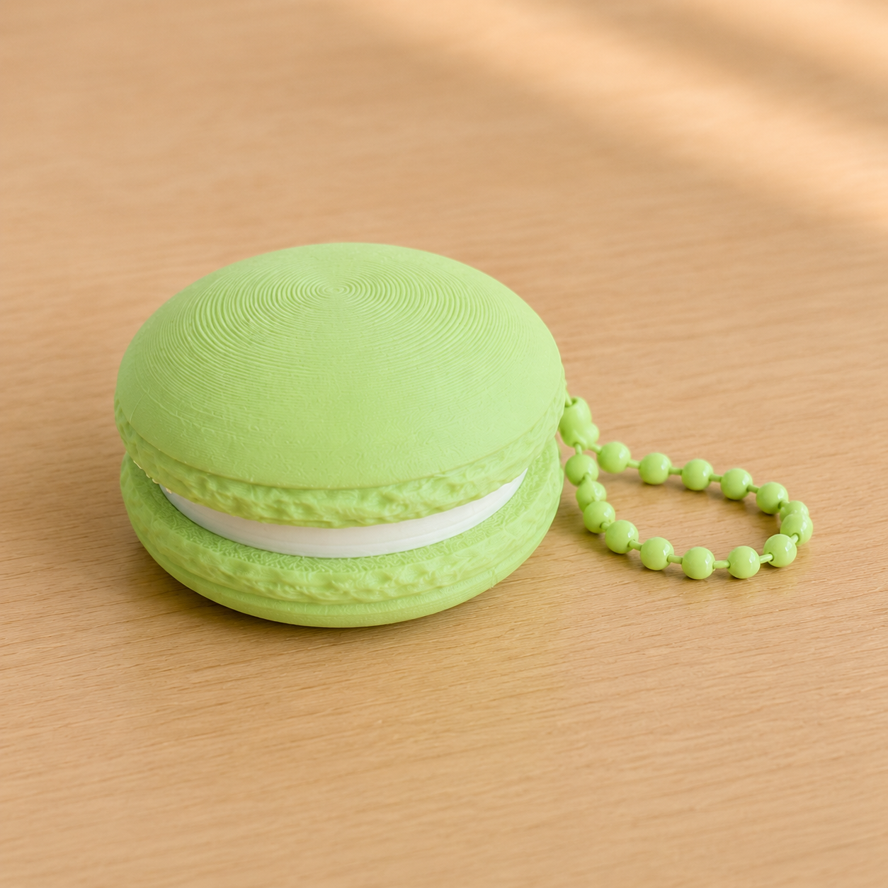 Apple Green 3D printed macaron fidget clicker keychain with white filling and matching ball chain