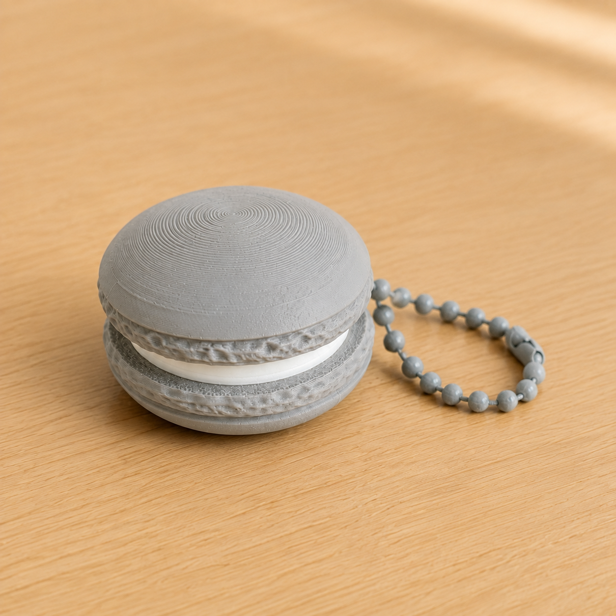 Ash Gray 3D printed macaron fidget clicker keychain with white filling and matching ball chain