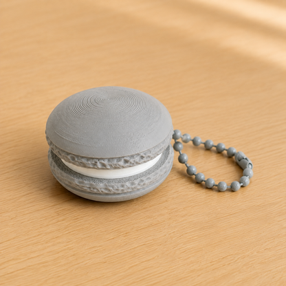 Ash Gray 3D printed macaron fidget clicker keychain with white filling and matching ball chain