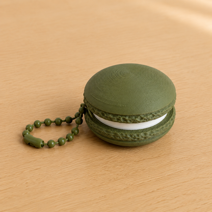 Dark Green 3D printed macaron fidget clicker keychain with white filling and matching ball chain
