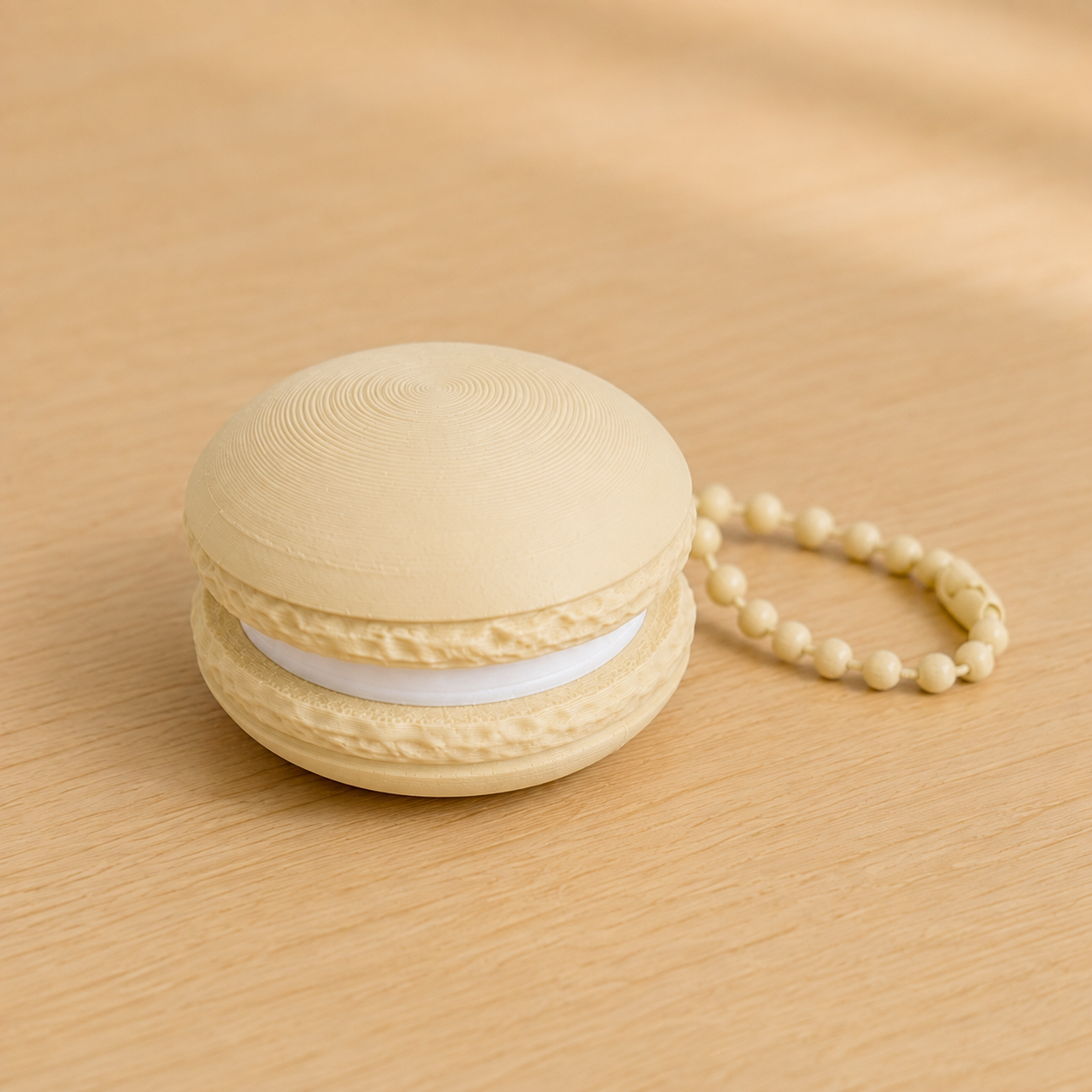 Desert Tan 3D printed macaron fidget clicker keychain with white filling and matching ball chain