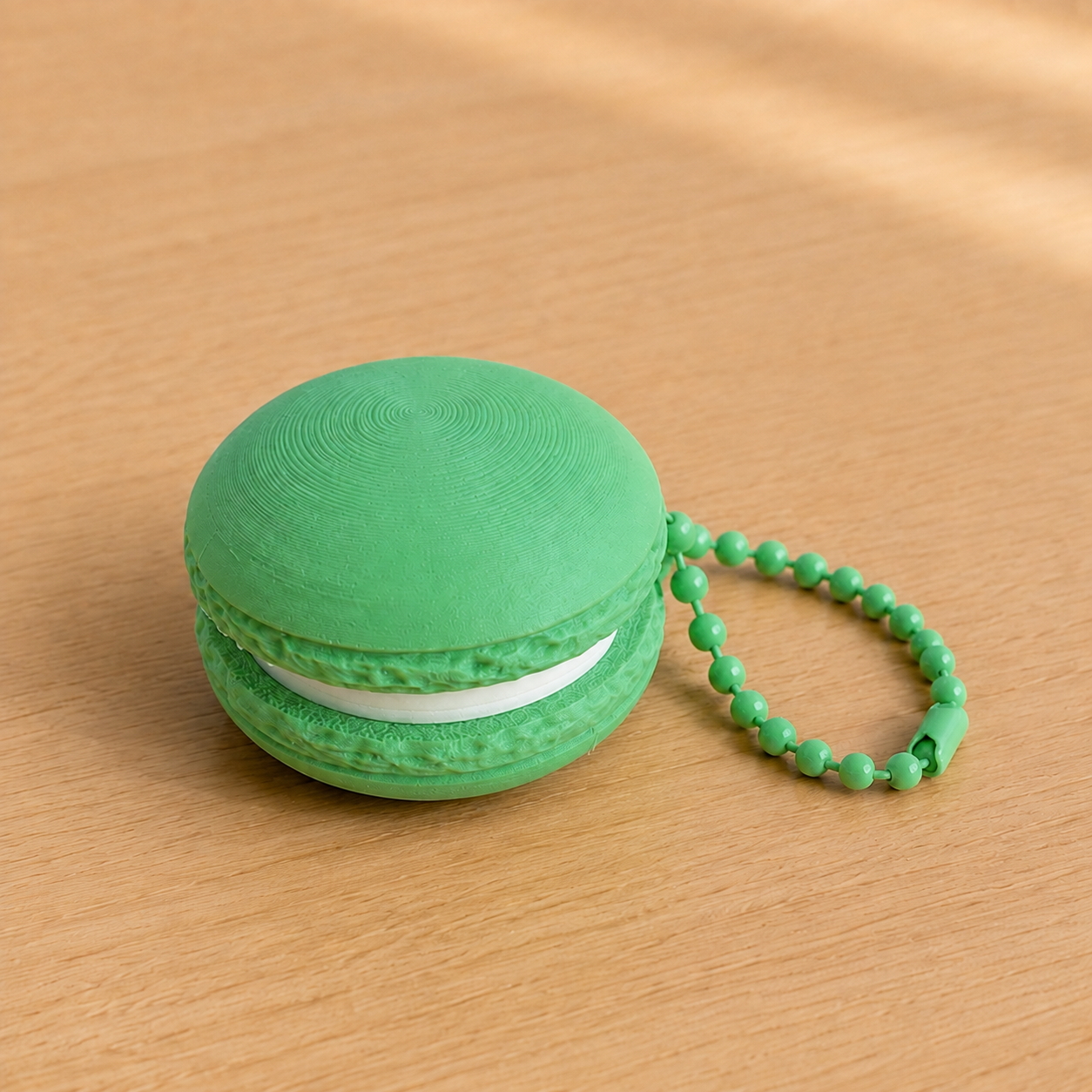 Grass Green 3D printed macaron fidget clicker keychain with white filling and matching ball chain