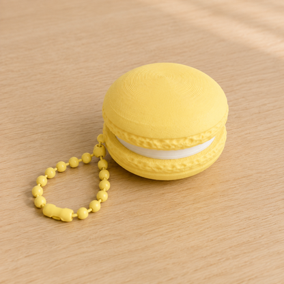 Lemon Yellow 3D printed macaron fidget clicker keychain with white filling and matching ball chain