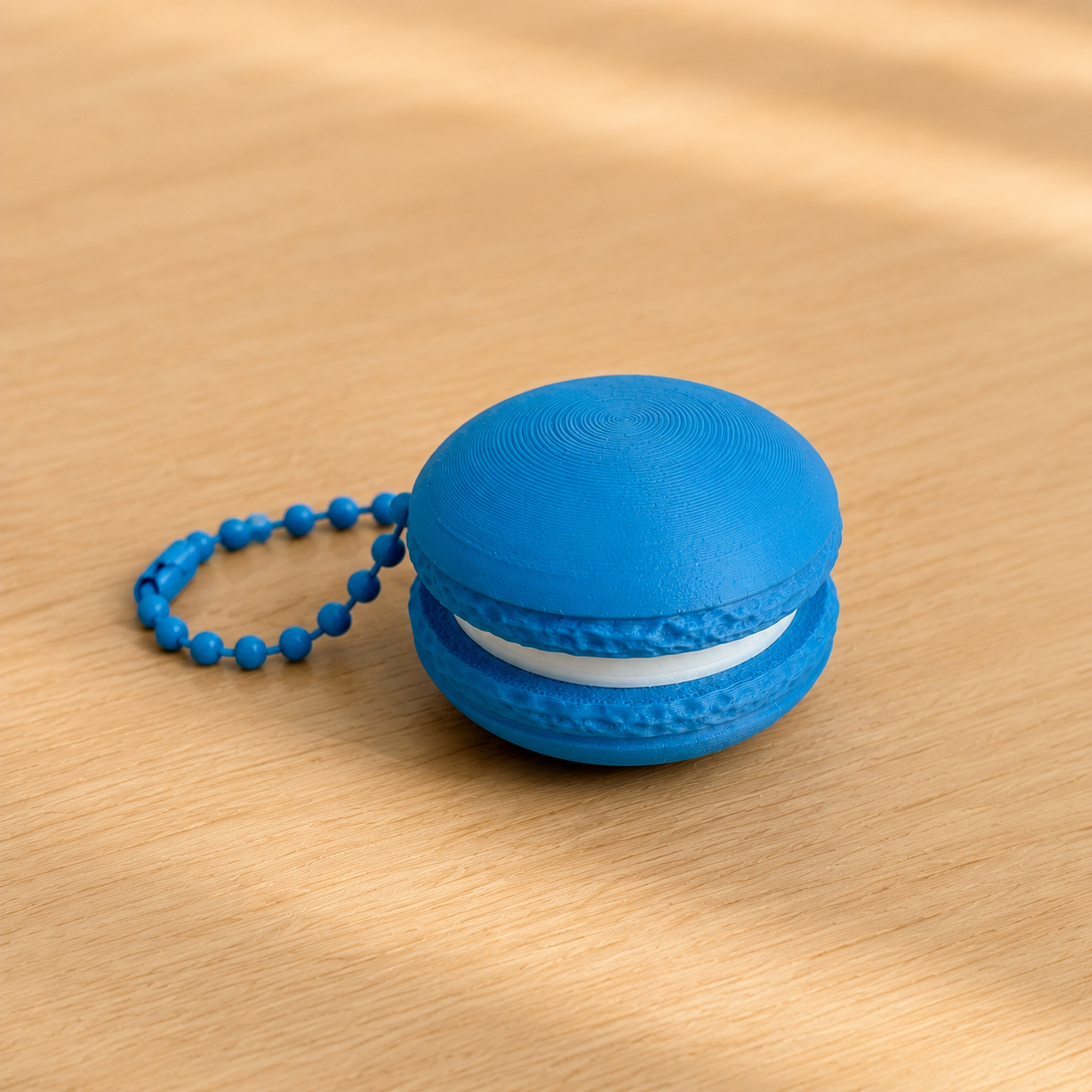 Marine Blue 3D printed macaron fidget clicker keychain with white filling and matching ball chain