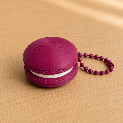 Plum 3D printed macaron fidget clicker keychain with white filling and matching ball chain