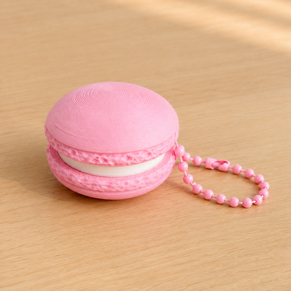 Sakura Pink 3D printed macaron fidget clicker keychain with white filling and matching ball chain