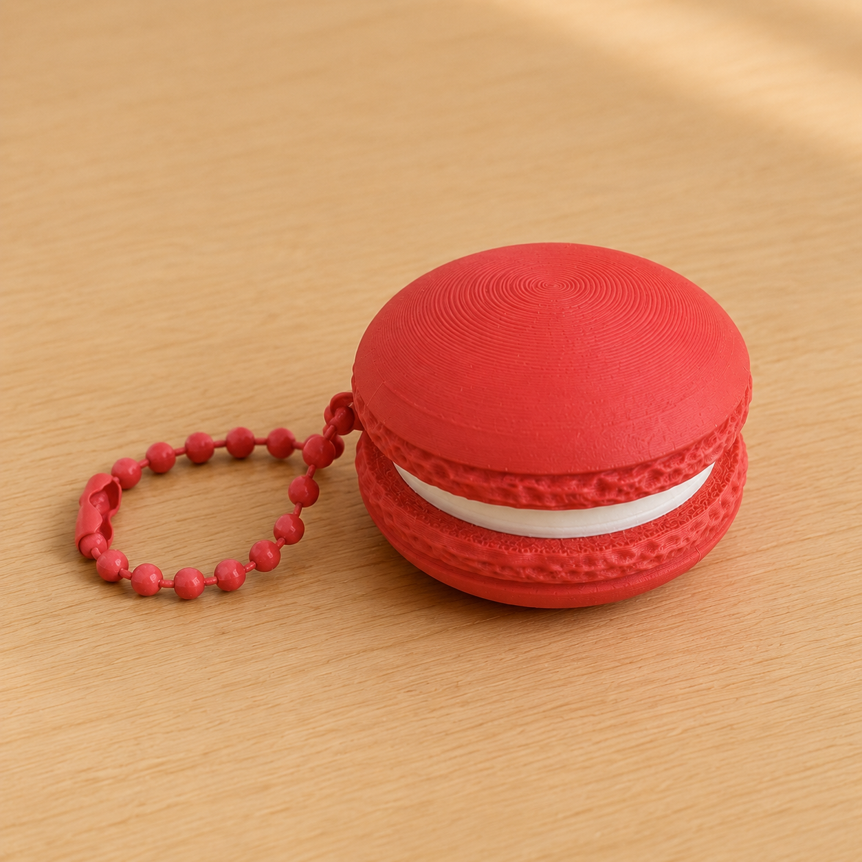 Scarlet Red 3D printed macaron fidget clicker keychain with white filling and matching ball chain