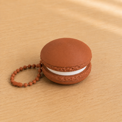 Terracotta 3D printed macaron fidget clicker keychain with white filling and matching ball chain