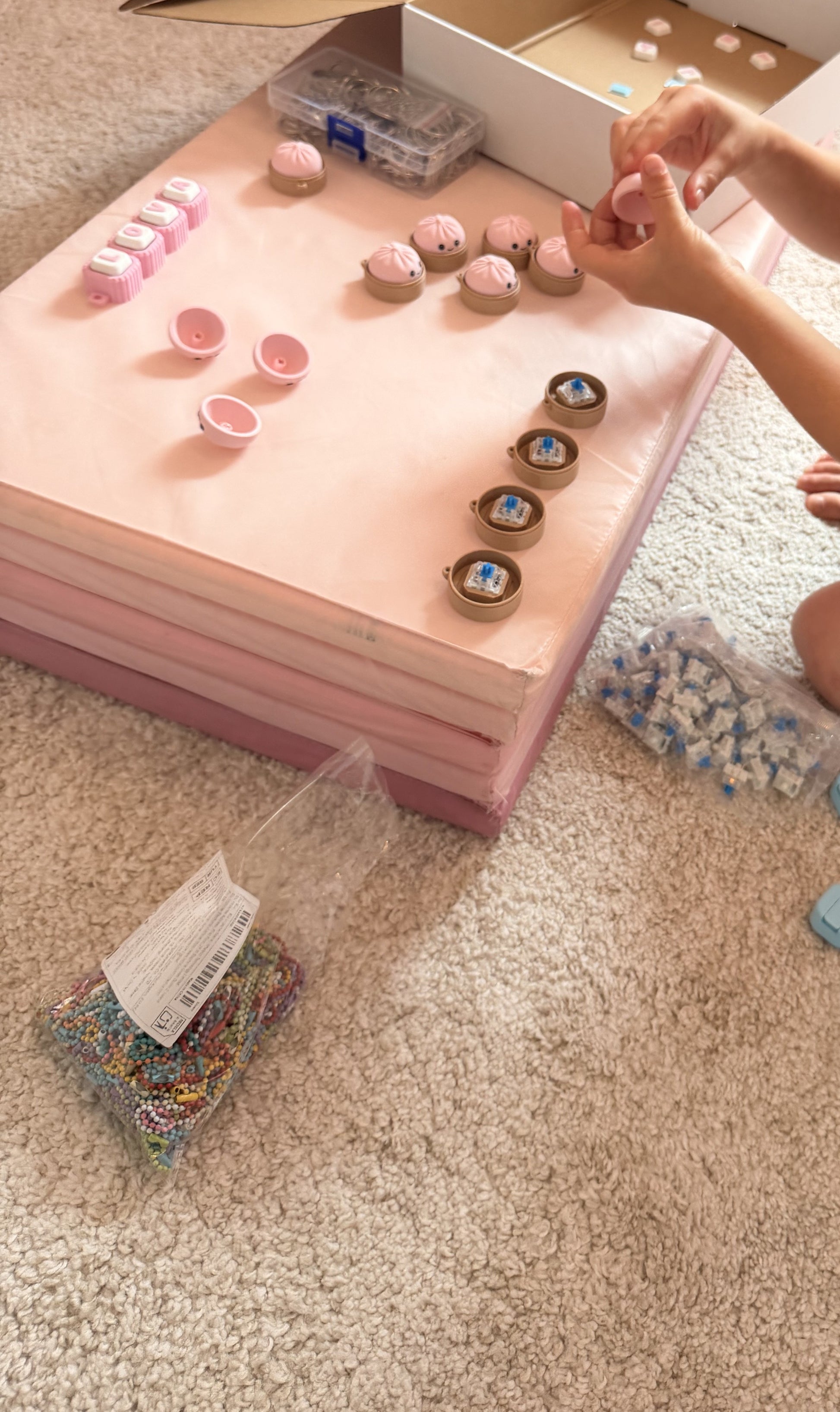 Lova assembling clicker keychains in the family workshop