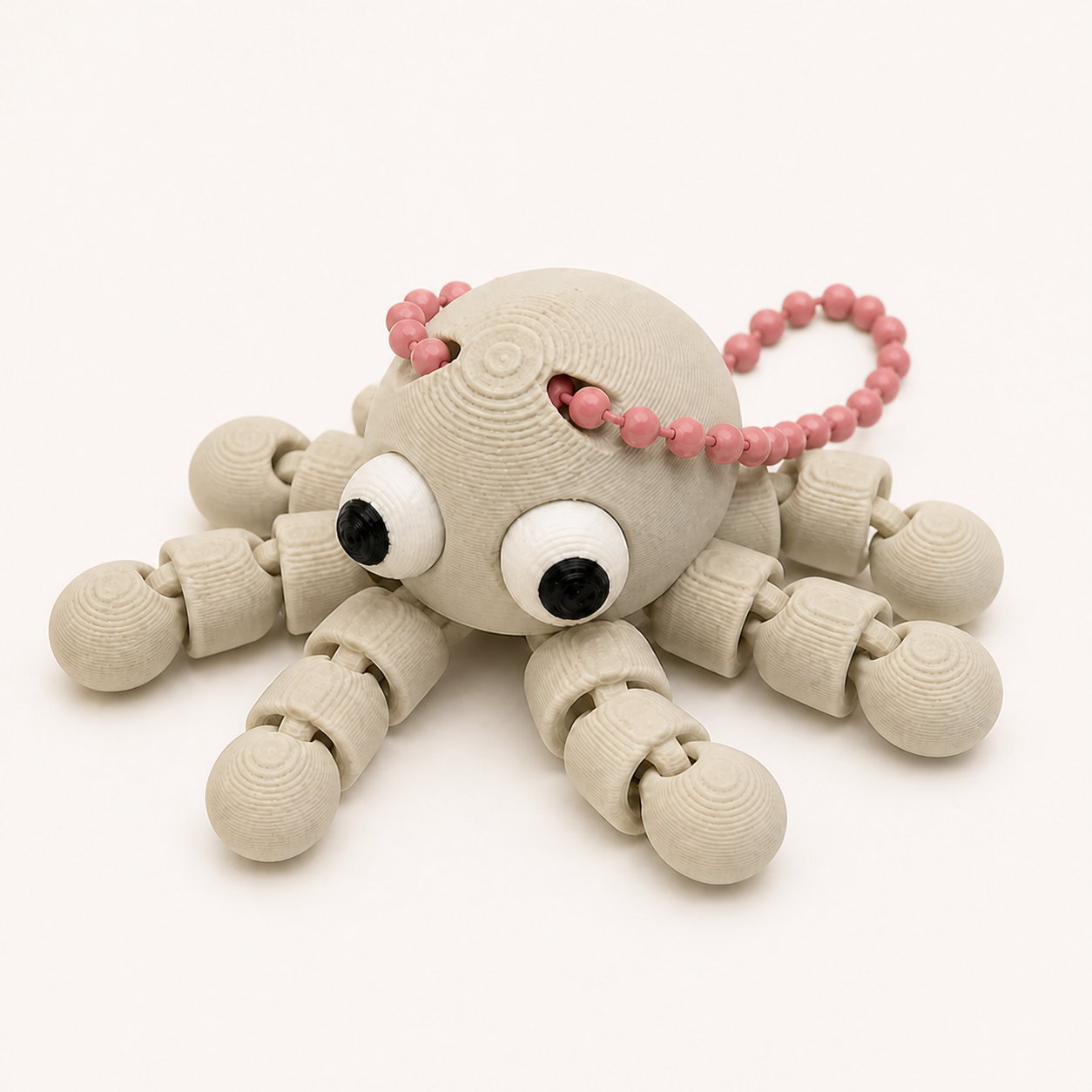 Bone White articulated octopus flexi keychain with white eyes, on a ball chain