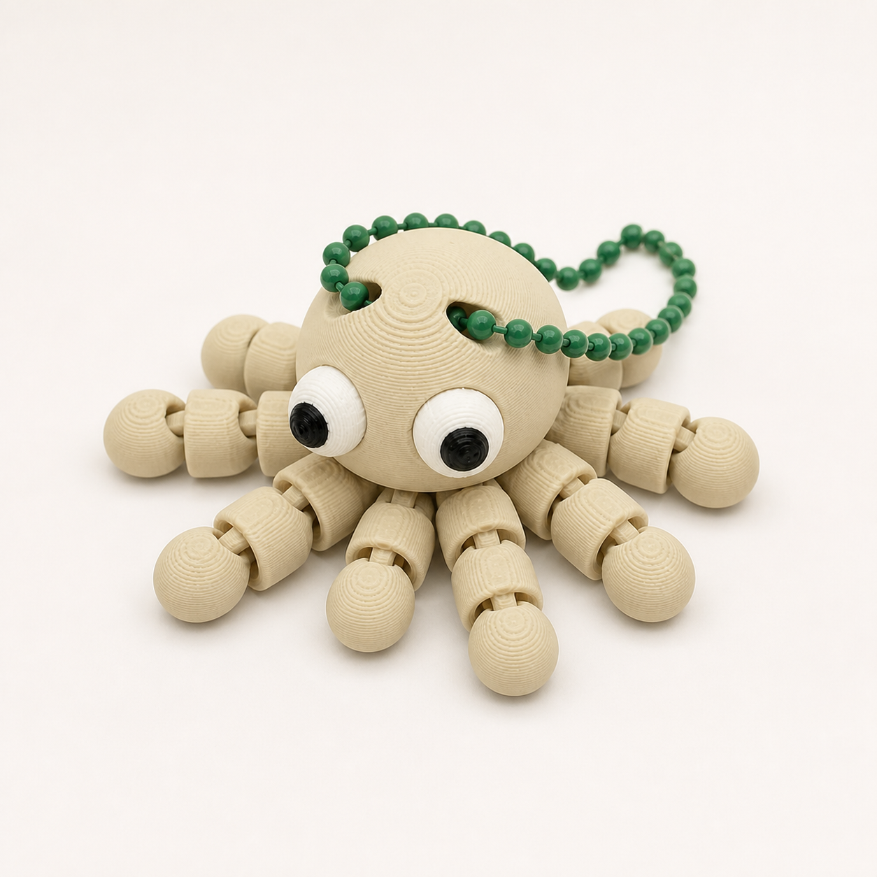Desert Tan articulated octopus flexi keychain with white eyes, on a ball chain