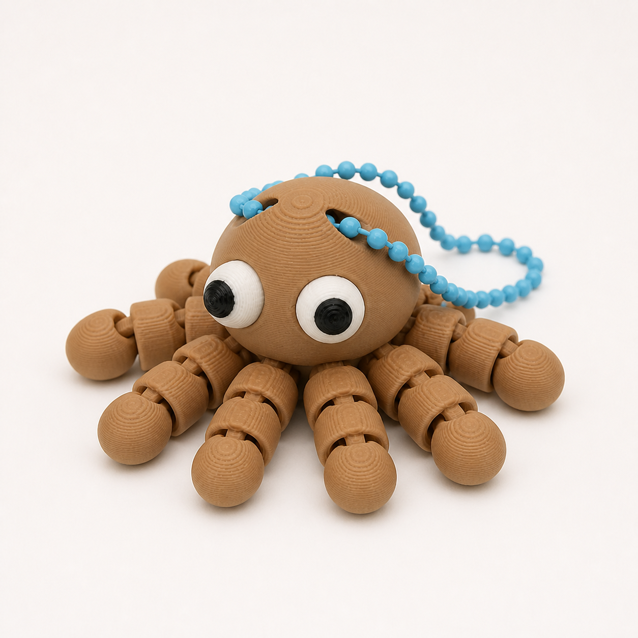 Caramel articulated octopus flexi keychain with white eyes, on a ball chain