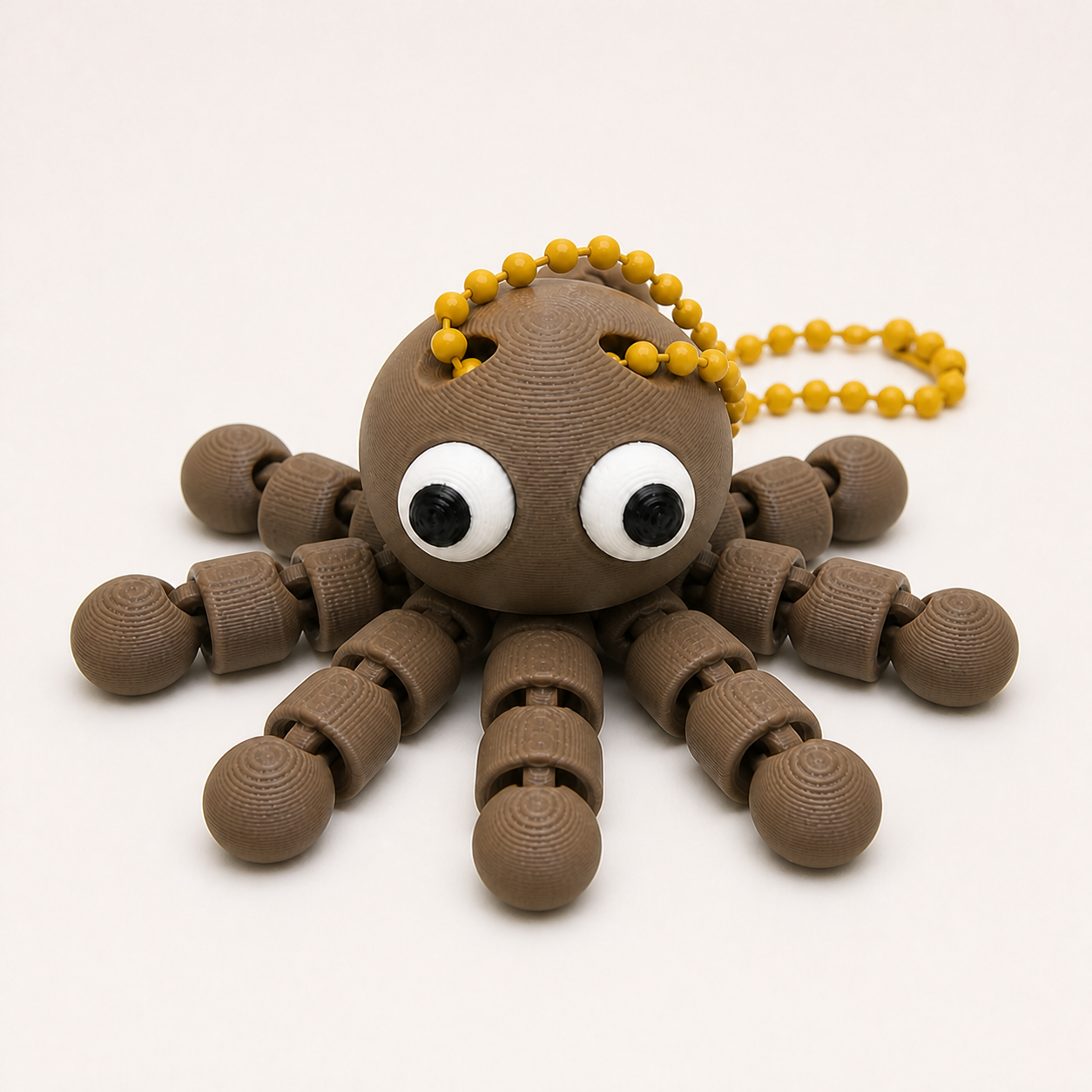 Dark Brown articulated octopus flexi keychain with white eyes, on a ball chain