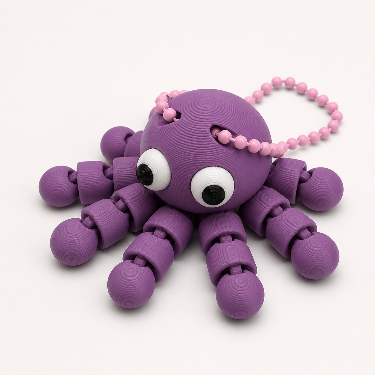 Plum articulated octopus flexi keychain with white eyes, on a ball chain