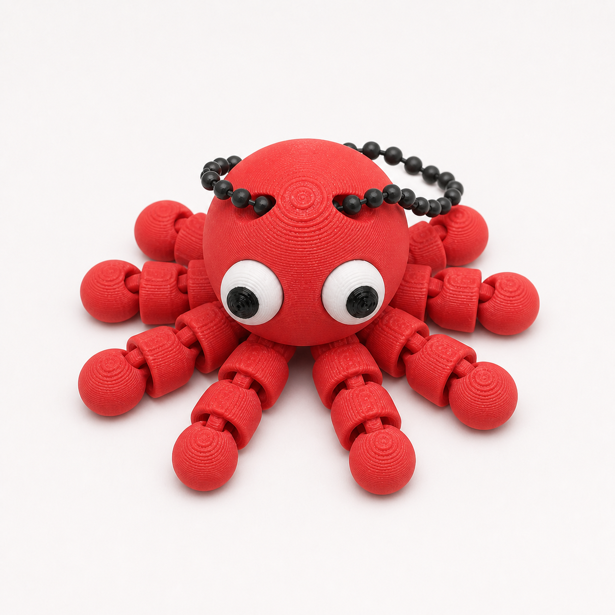 Scarlet Red articulated octopus flexi keychain with white eyes, on a ball chain