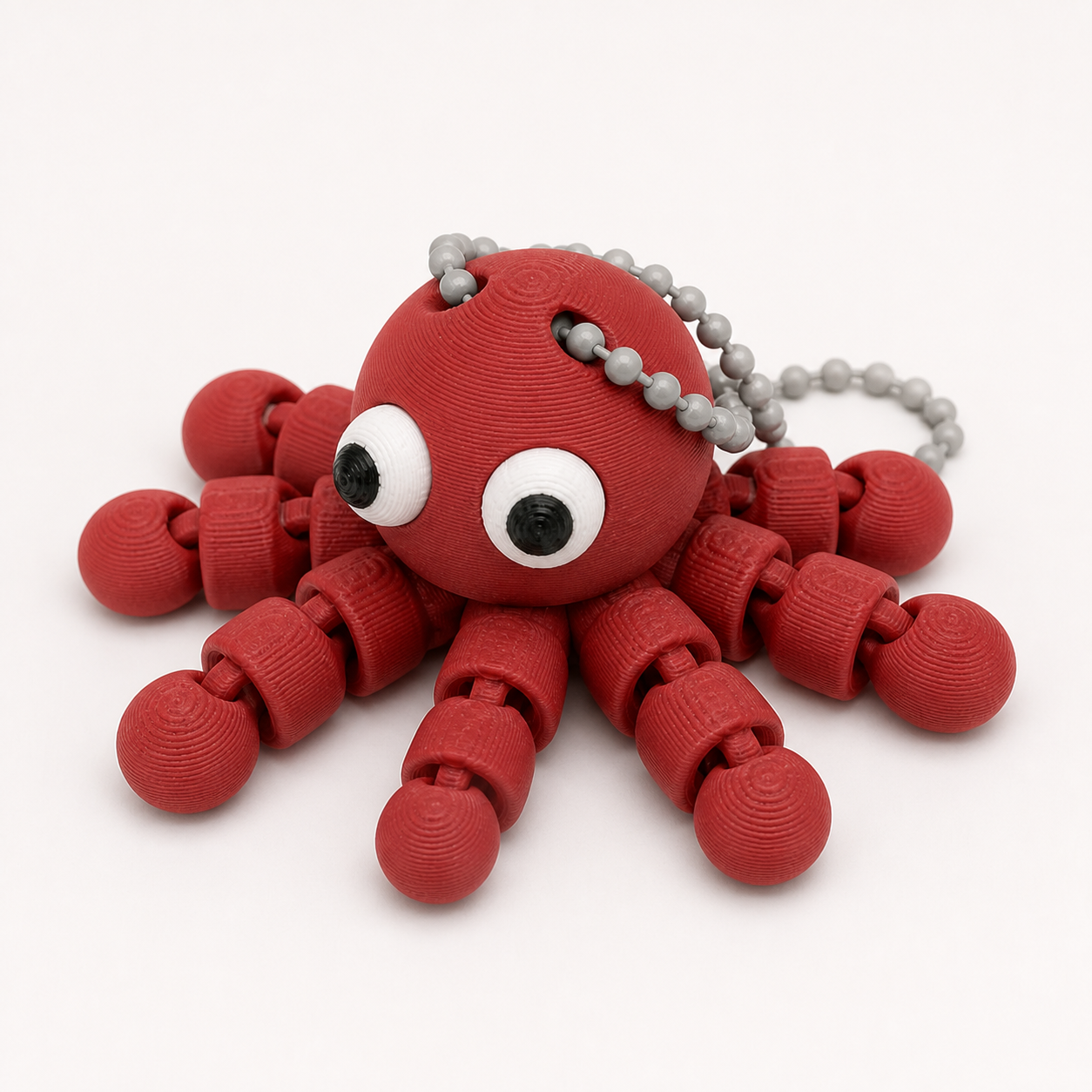 Dark Red articulated octopus flexi keychain with white eyes, on a ball chain