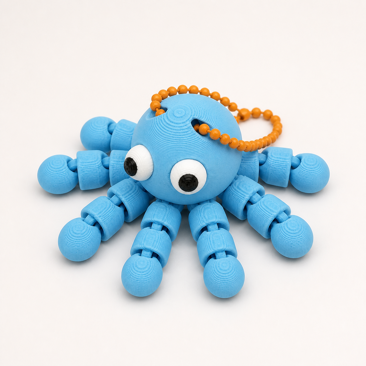Sky Blue articulated octopus flexi keychain with white eyes, on a ball chain