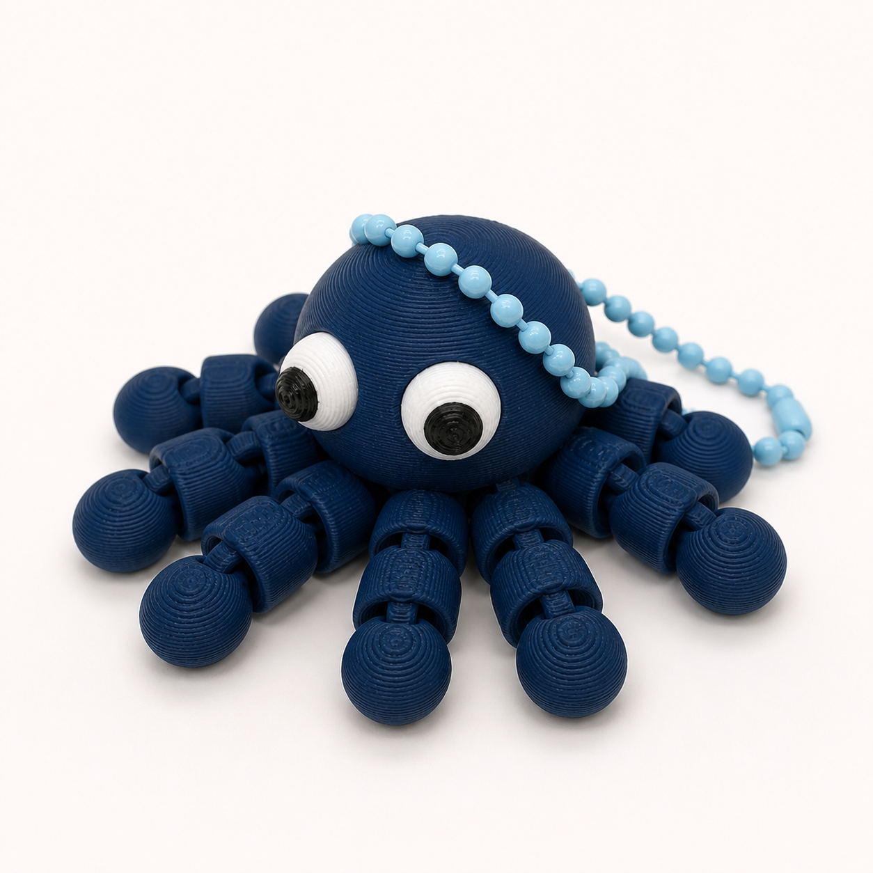Dark Blue articulated octopus flexi keychain with white eyes, on a ball chain