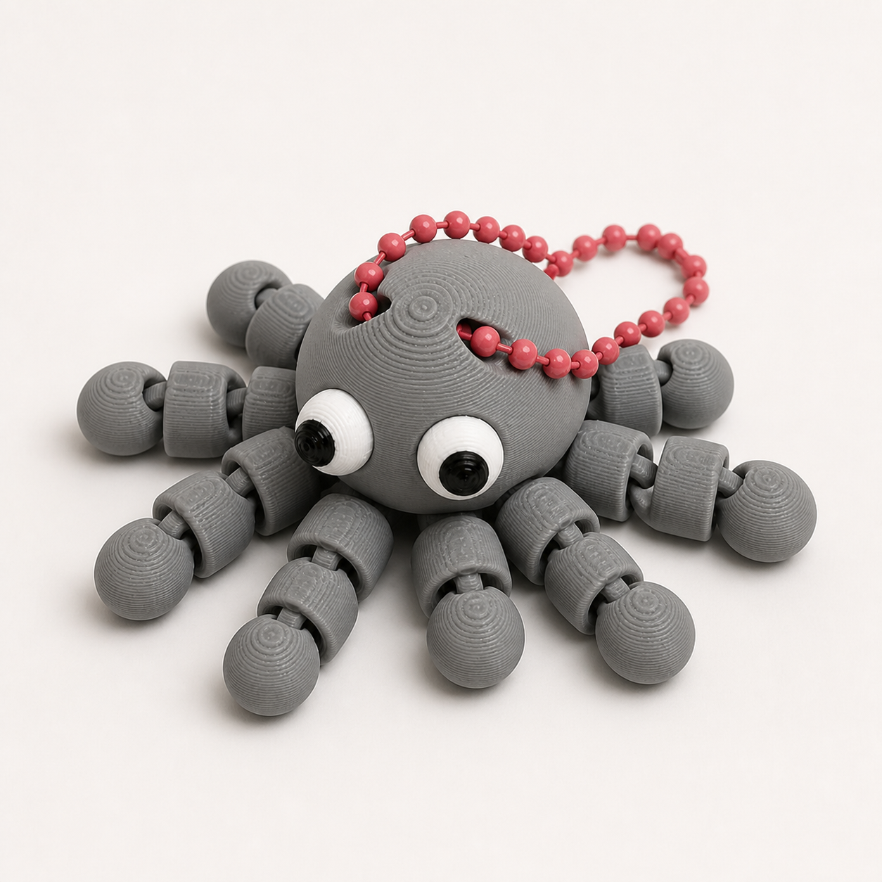 Nardo Gray articulated octopus flexi keychain with white eyes, on a ball chain