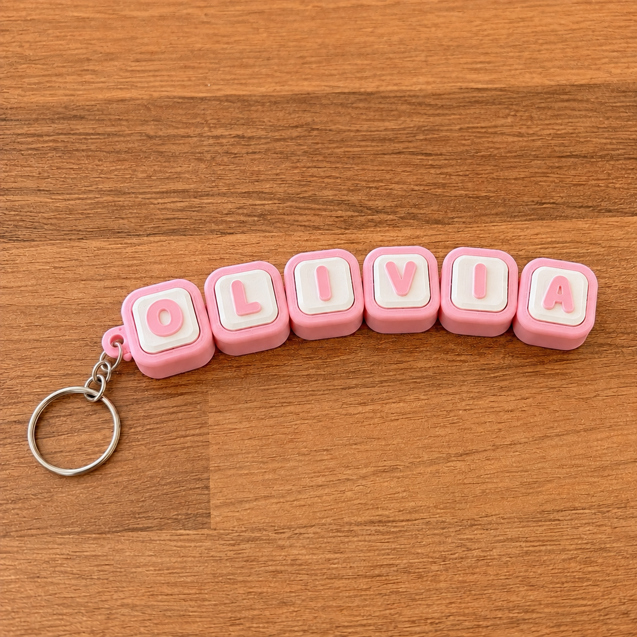 Personalized name tag clicker keyring 'Olivia' — pink steel keyring, 3D printed