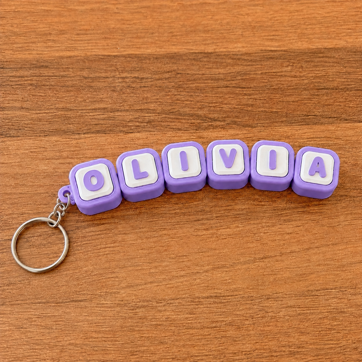 Personalized name tag clicker keyring 'Olivia' — purple steel keyring, 3D printed