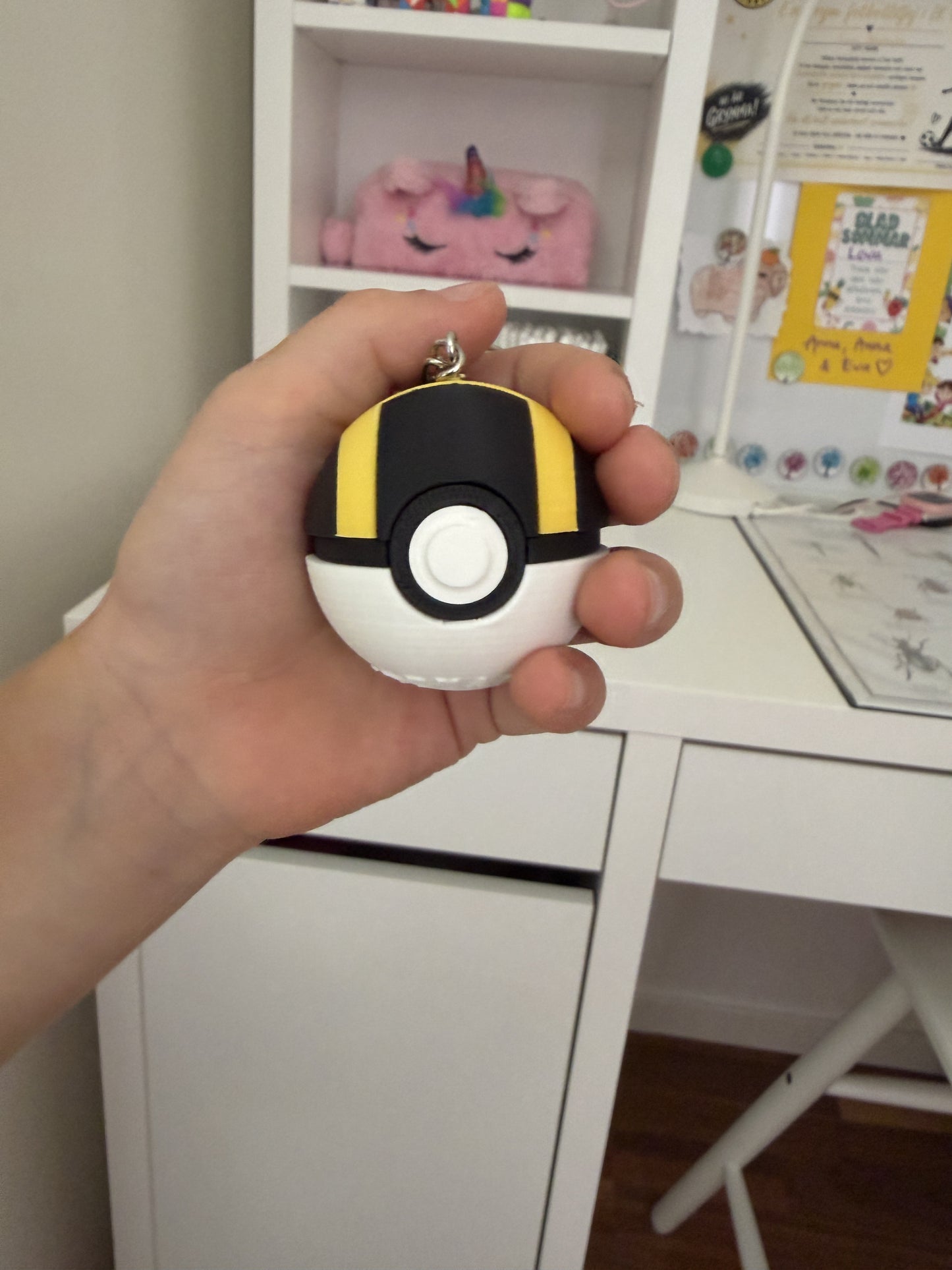 Yellow and black Ultra Ball clicker keychain
